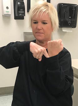 Figure 2: Use the index finger of the dominant hand to represent a periodontal probe being walked around the sulcus, which is represented by the cuff on the lab coat. Figure 2: Use the index finger of the dominant hand to represent a periodontal probe being walked around the sulcus, which is represented by the cuff on the lab coat.