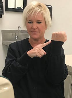 Figure 3: Pull the cuff of the lab coat above the wrist, which represents the CEJ, to show how inflammation can cause the gum line to cover more of the crown of the tooth.