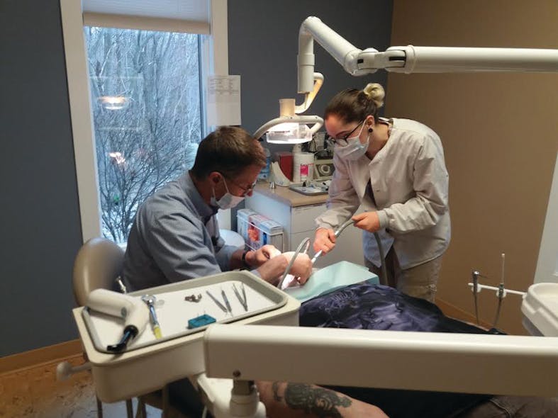 Andrew &ldquo;Dutch&rdquo; Nyboer, DDS, and Cyndy Nyboer, assistant, treat a patient at the Love in Action Tri-Cities dental clinic.