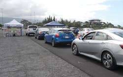 Autos line up for initial screening Friday at the Old Kona Airport drive up COVID-19 testing. Autos line up for initial screening Friday at the Old Kona Airport drive up COVID-19 testing.