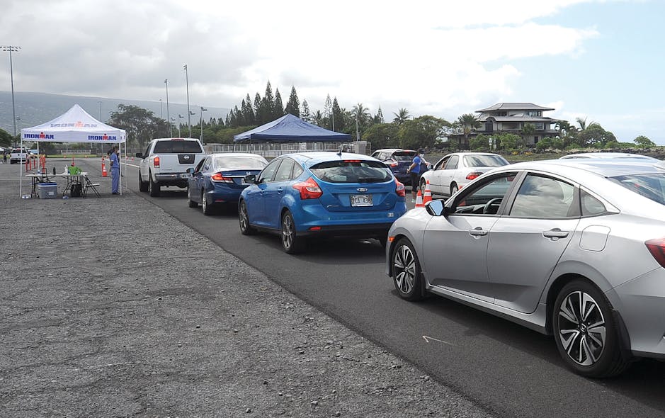 Autos line up for initial screening Friday at the Old Kona Airport drive up COVID-19 testing.