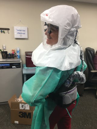 The author wearing her air-purifying respirator.