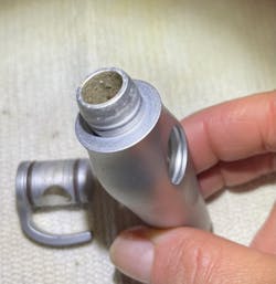 Figure 2: HVE adapter with the 'Gorilla Glue' of biofilm. It had to soak it overnight to get it apart, so Hill took it home (hence no gloves). Figure 2: HVE adapter with the 'Gorilla Glue' of biofilm. It had to soak it overnight to get it apart, so Hill took it home (hence no gloves).