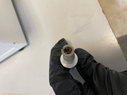 Figure 2: Low-volume evacuation tubing occluded with prophy paste and biofilm. Figure 2: Low-volume evacuation tubing occluded with prophy paste and biofilm.