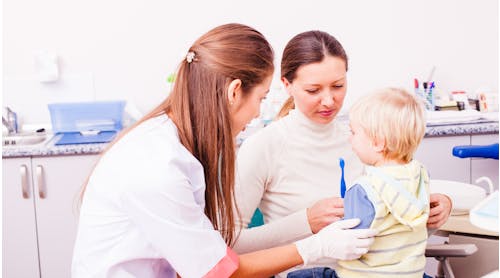 Child And Parent At Dentist