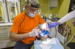 Veleriy Gorbenko, Ukrainian military dentist, performs endodontic treatment in a mobile dental clinic.