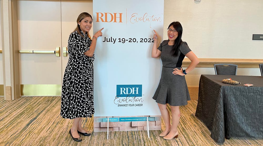 An Chi Do, right, stops by the RDH Evolution sign with fellow hygienist Maxine Cordova.