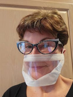 Figure 1: Susie Keepper wears a mask that enables her hard-of-hearing patients to lip read.
