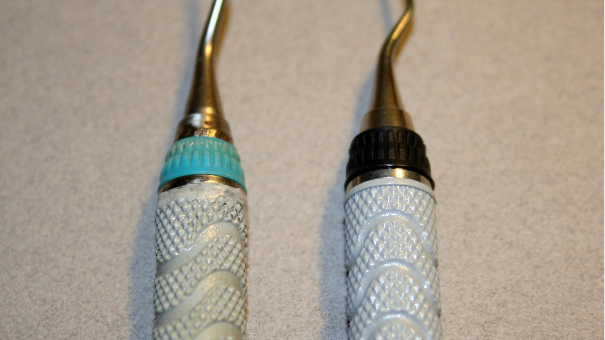 Figures 3A and 3B: Melted resin handle&mdash;this 5/6 curette with resin handle was retipped and returned with a melted, recontoured resin handle. Notice also the gap between the instrument cone and silicone grip.