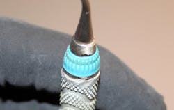 Figure 3: Melted resin handle. This 5/6 curette with resin handle was retipped and returned with a melted, recontoured resin handle. Also notice the gap between the instrument cone and silicone grip. Figure 3: Melted resin handle. This 5/6 curette with resin handle was retipped and returned with a melted, recontoured resin handle. Also notice the gap between the instrument cone and silicone grip.