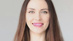 Smiling woman showing teeth covered in purple disclosing solution Smiling woman showing teeth covered in purple disclosing solution