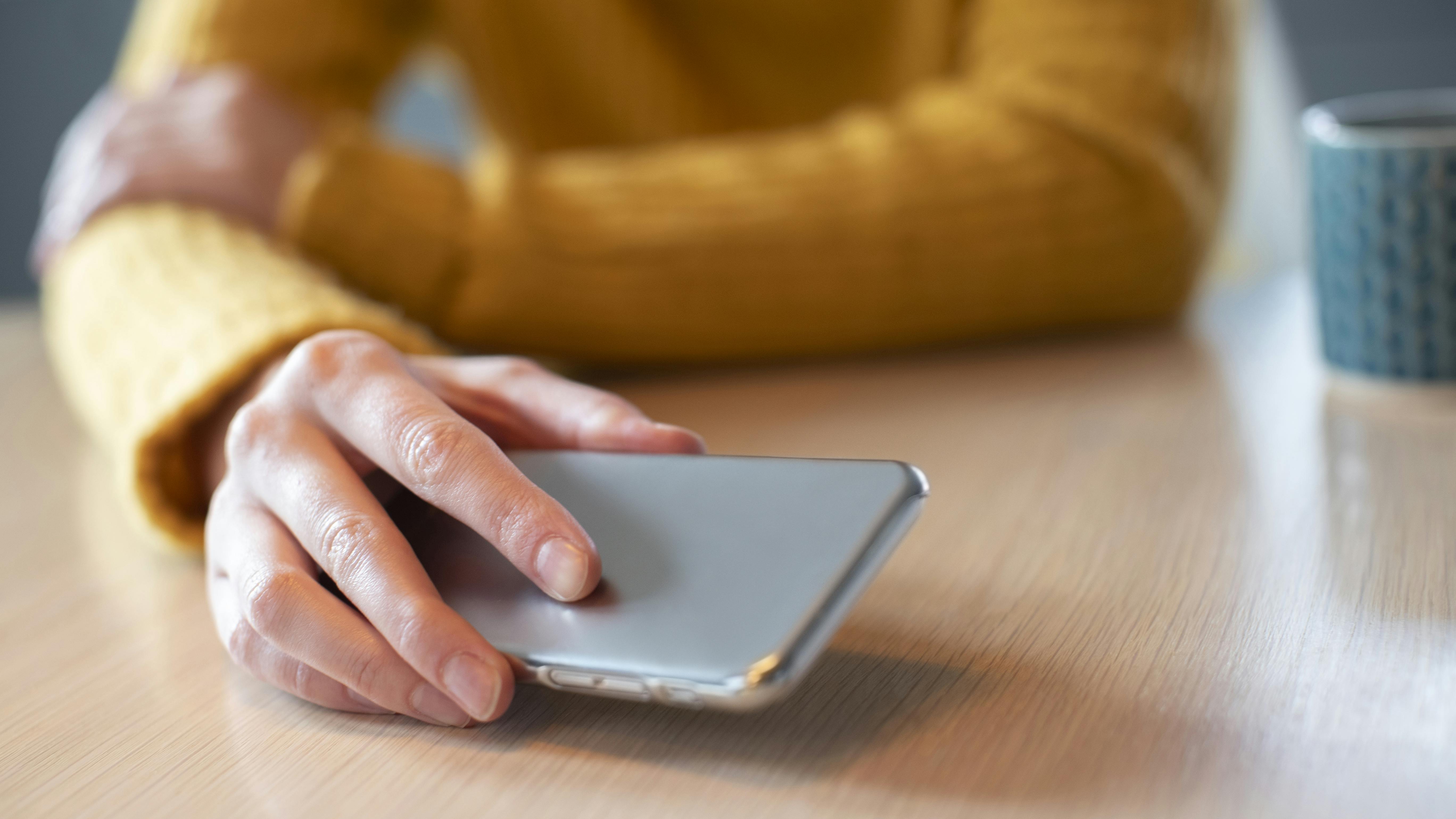 Woman laying down her phone on the table