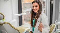 dental-pro-holding-hand-instrument-in-operatory dental-pro-holding-hand-instrument-in-operatory