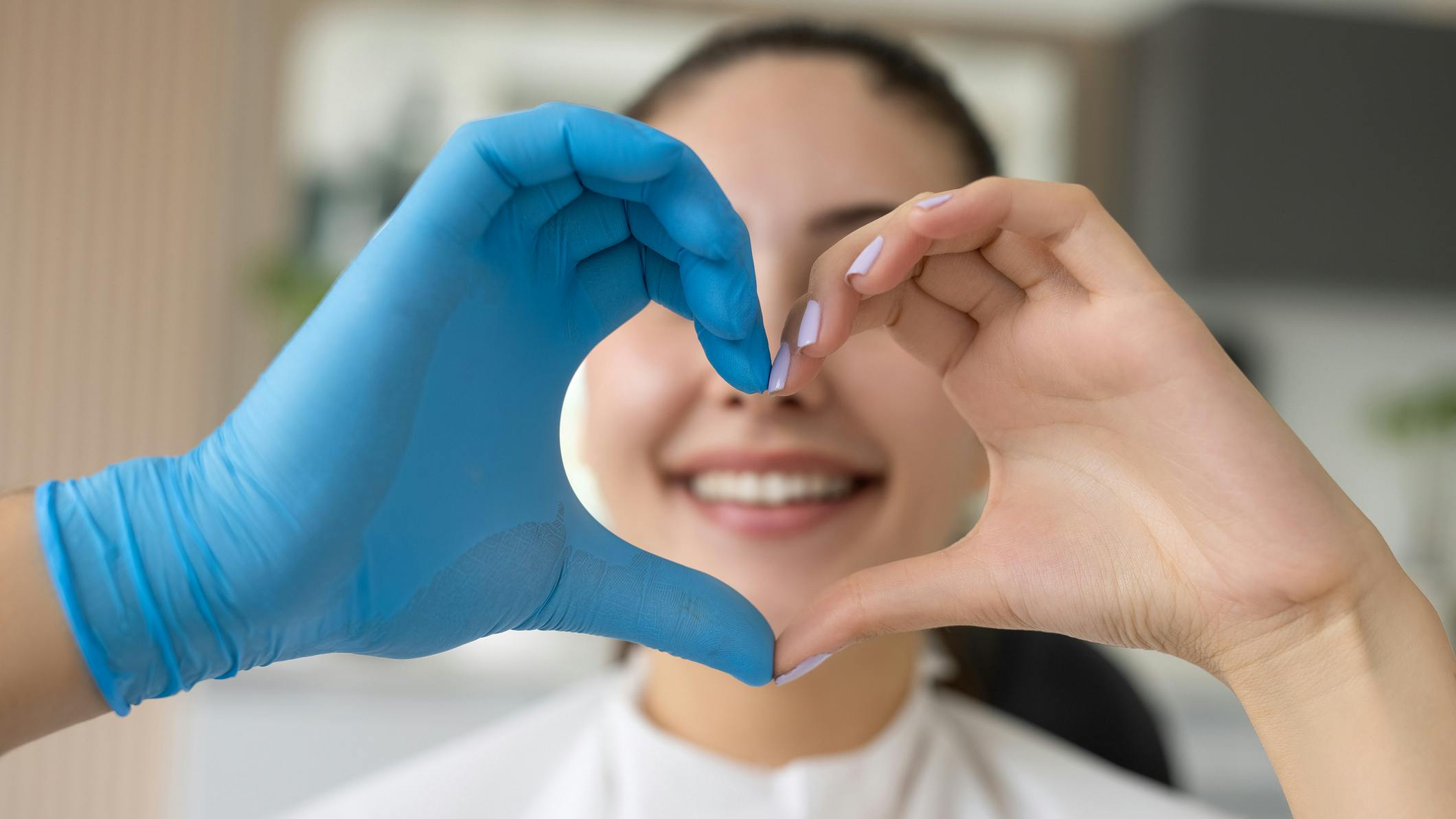 two heart hands in dental op in front of patient