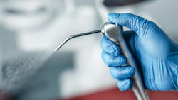 gloved-hand-holding-air-water-syringe gloved-hand-holding-air-water-syringe