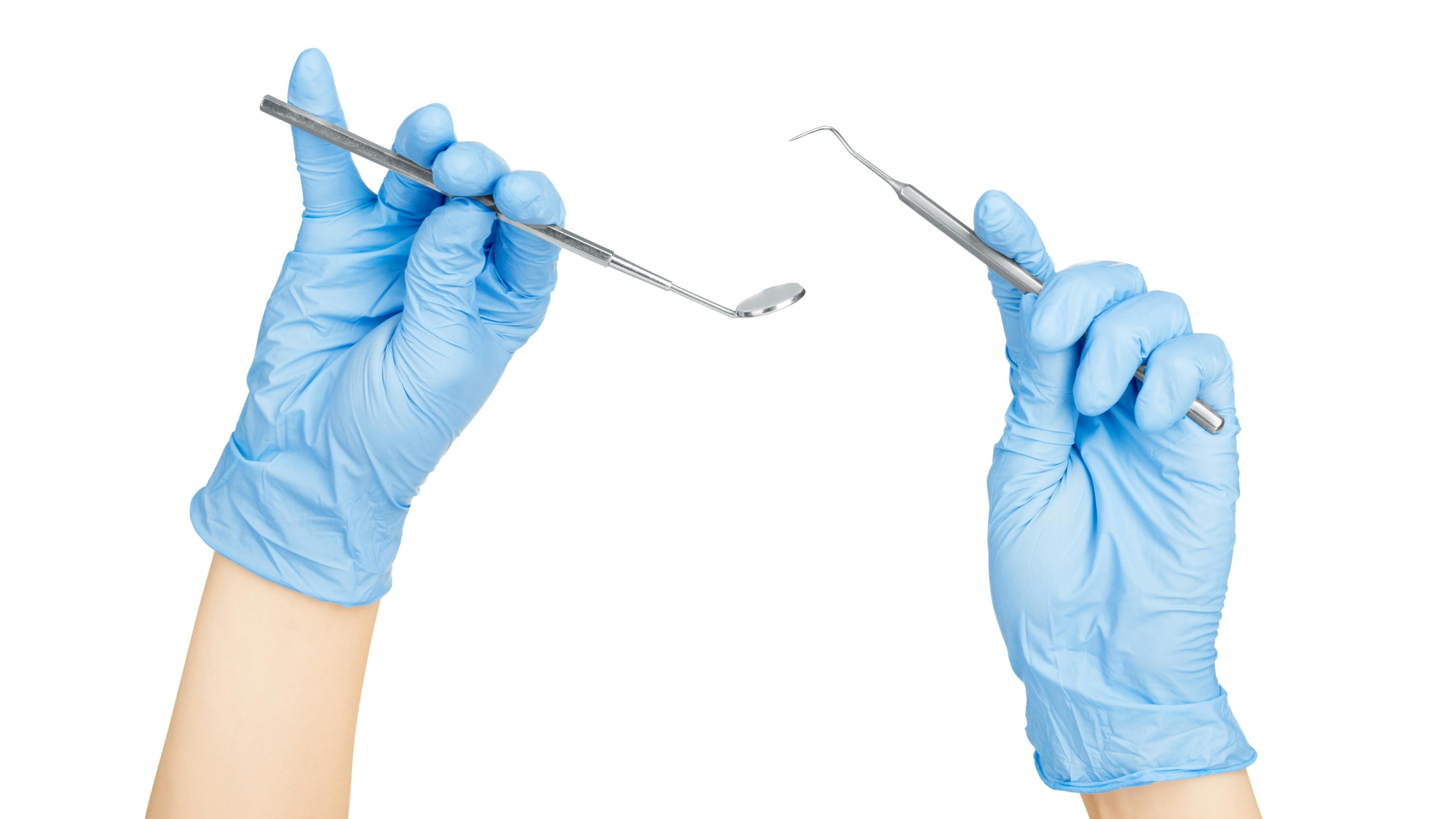 The hands of a dental hygienist