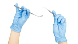 The hands of a dental hygienist The hands of a dental hygienist