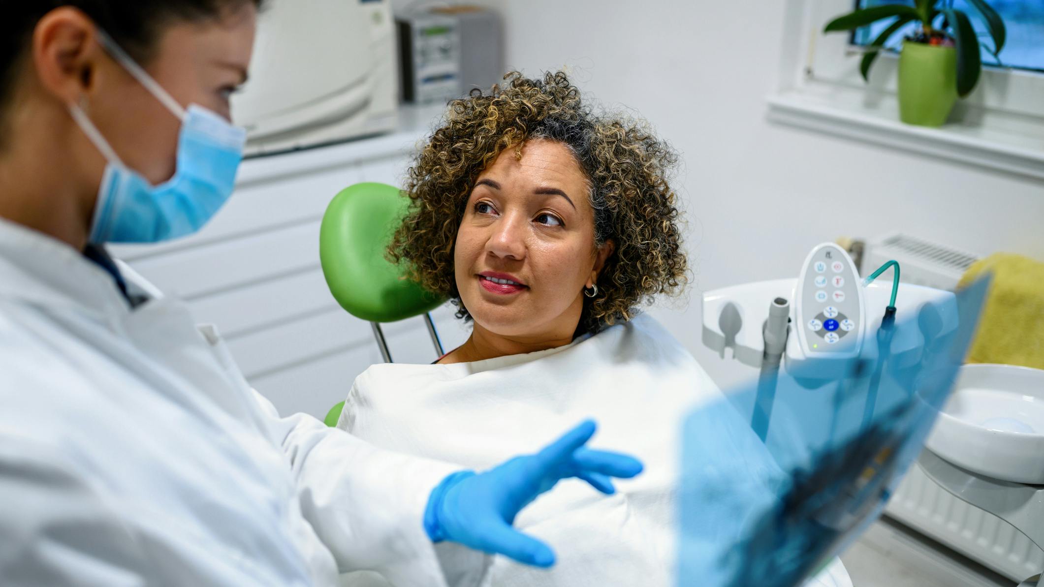 dental hygirnist educating dental patient about best home-care tools