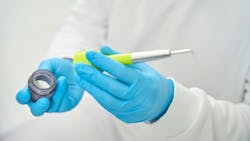 Gloved hands holding air polisher and erythritol powder Gloved hands holding air polisher and erythritol powder