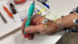 hand holding a dental instrument hand holding a dental instrument