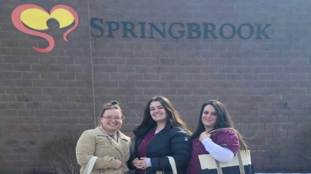 From left, Haley Floess, Alexis Riley, and Brittany Fiumara enjoy volunteering at Springbrook.