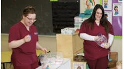 Haley Floess, left, and a colleague volunteer to provide oral health education for underserved children. Haley Floess, left, and a colleague volunteer to provide oral health education for underserved children.