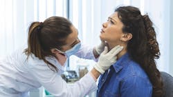 dental professional checking a patient for thyroid abnormalities dental professional checking a patient for thyroid abnormalities