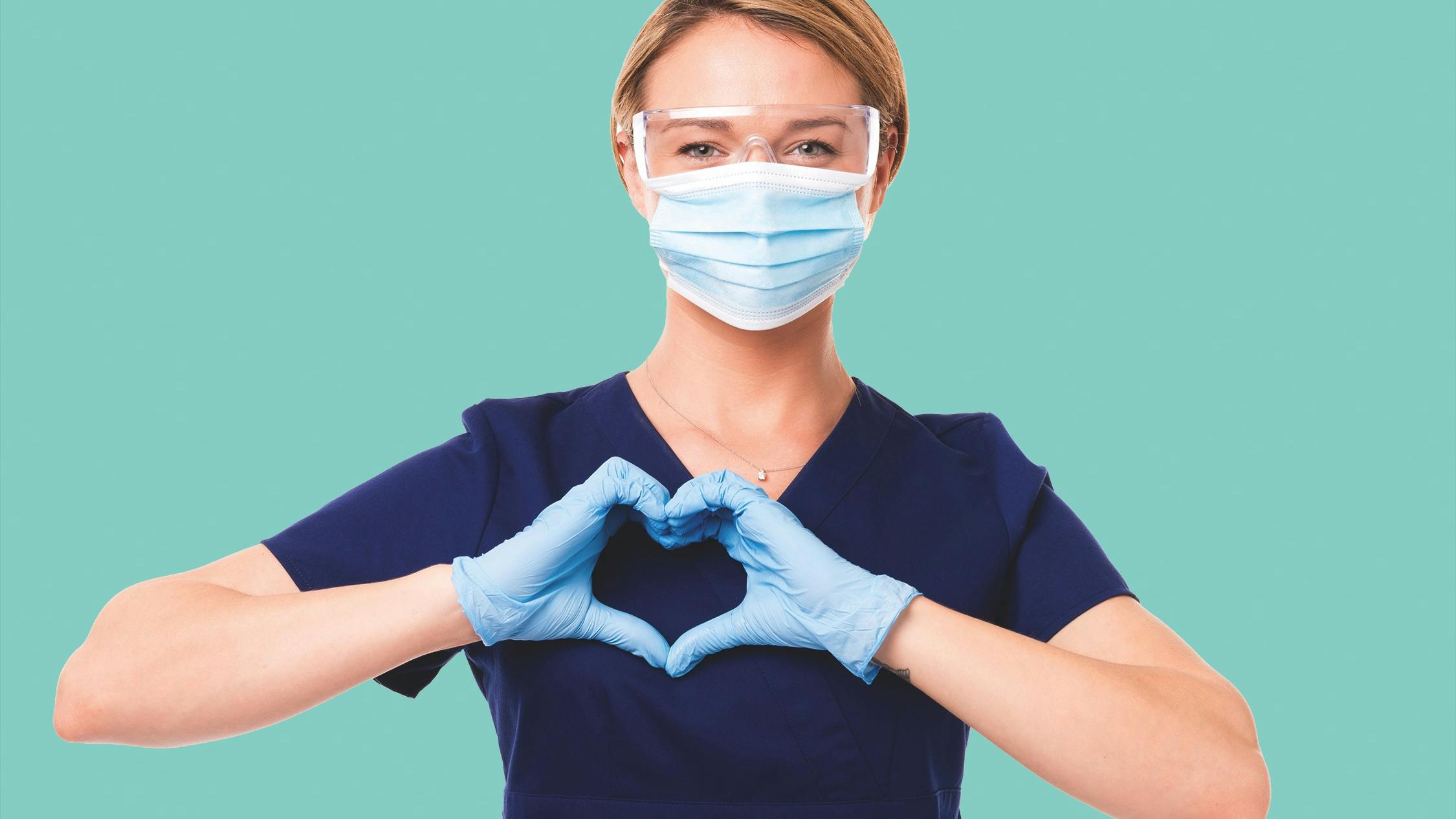 dental hygienist making a heart sign with her gloved hands