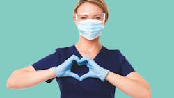 dental hygienist making a heart sign with her gloved hands dental hygienist making a heart sign with her gloved hands