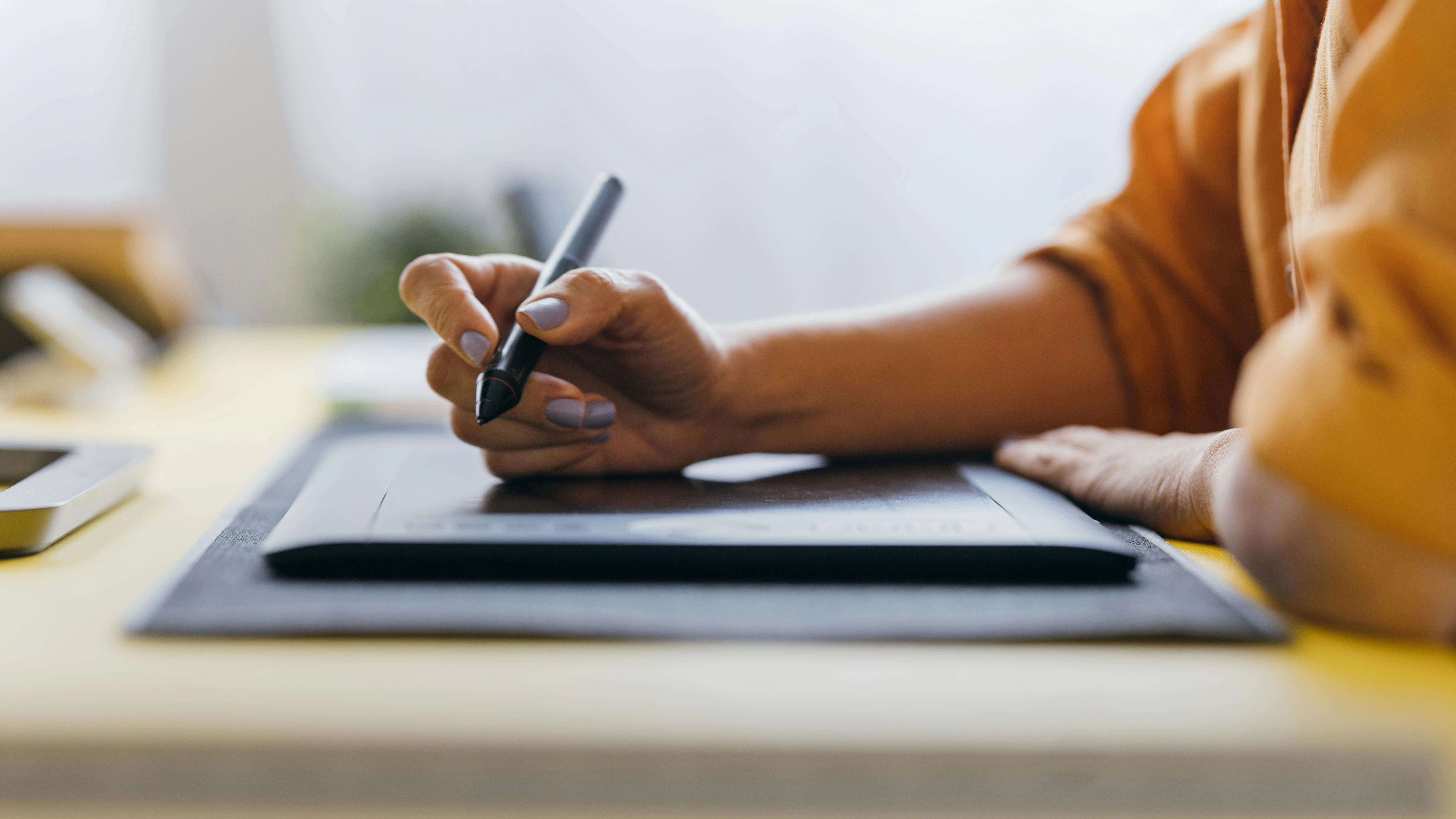 Dental professional using a digital drawing tablet to create artwork for a creative side gig