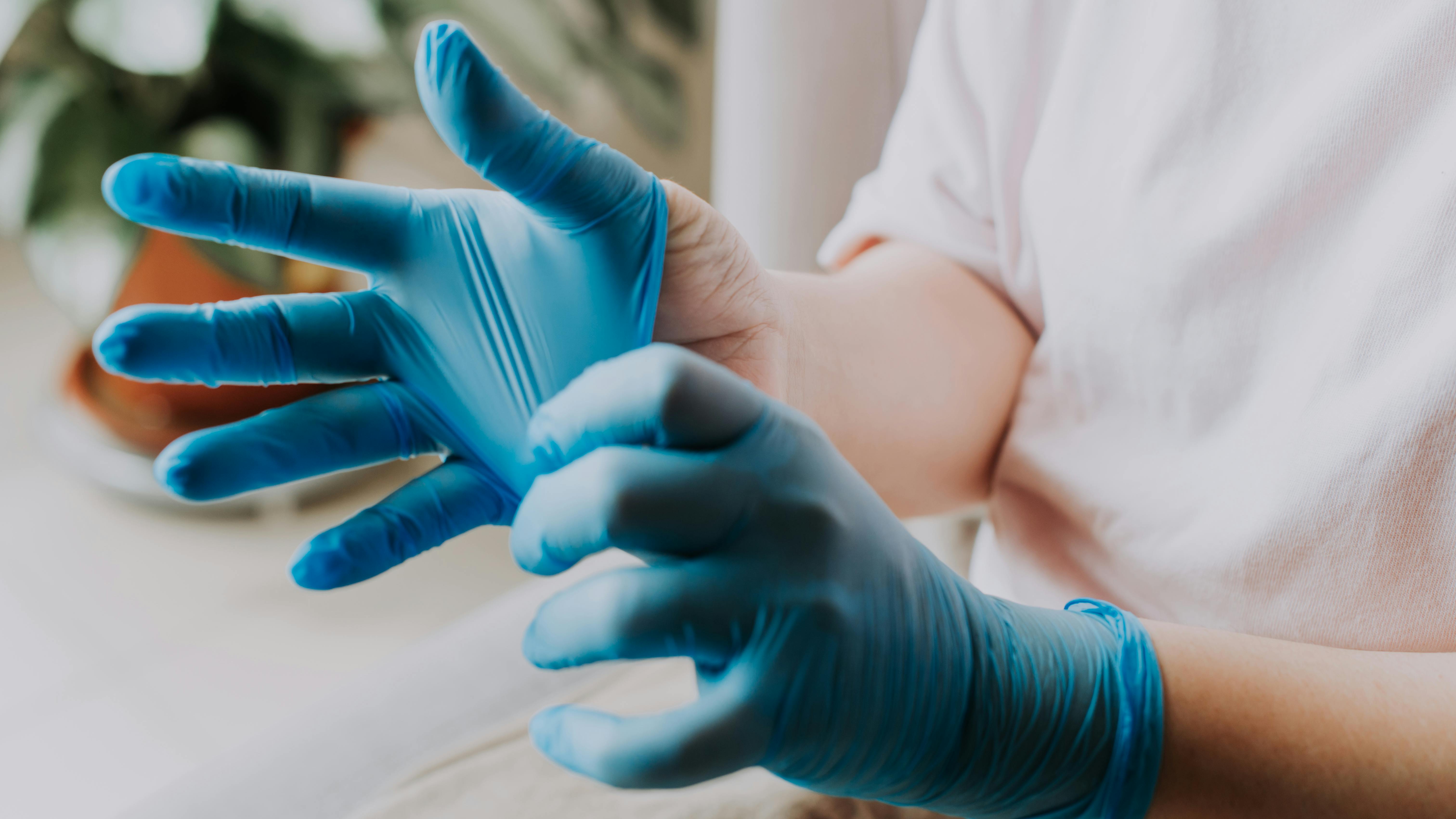 person putting on medical gloves