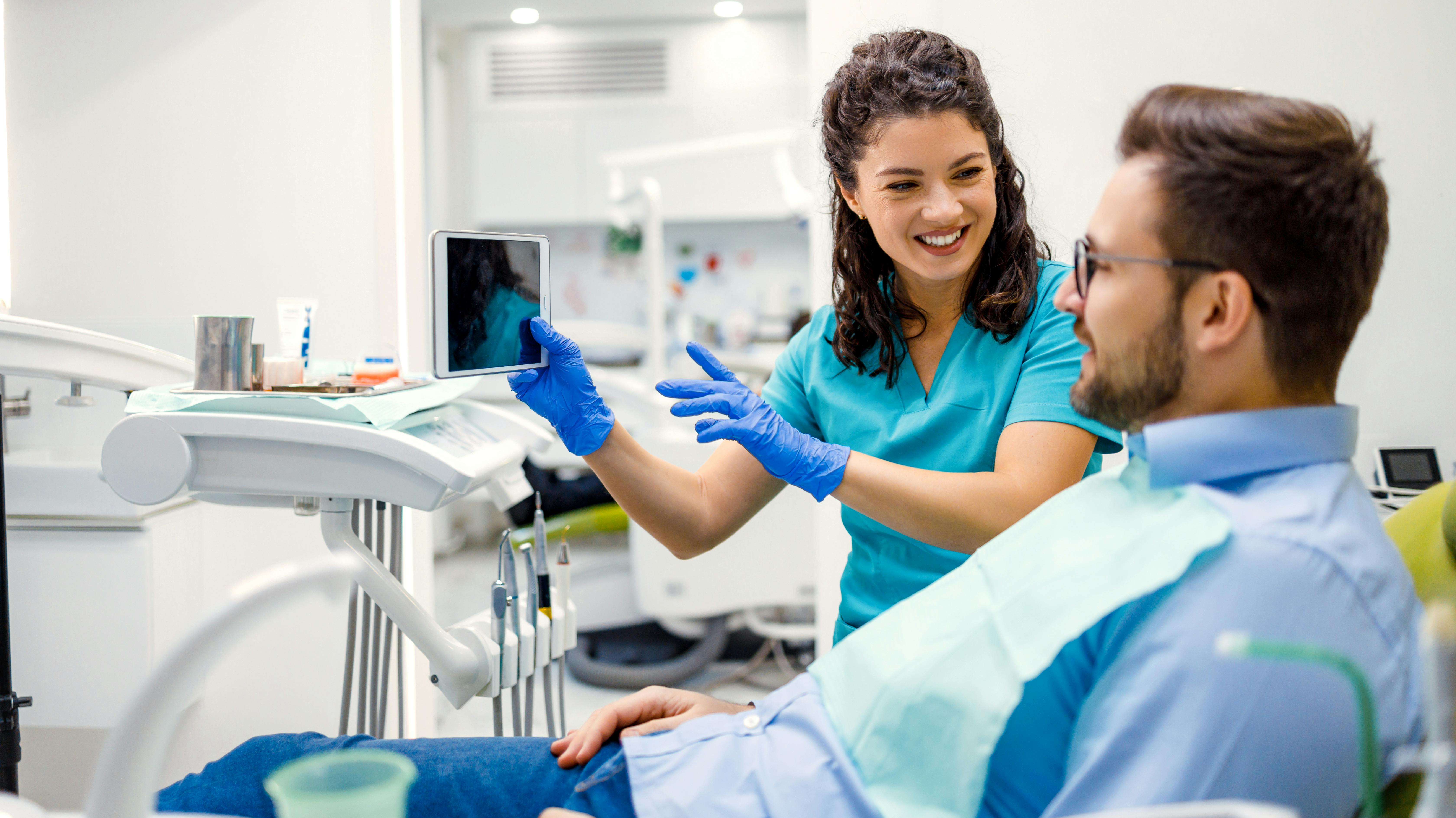 dental hygienist communicating with a dental patient