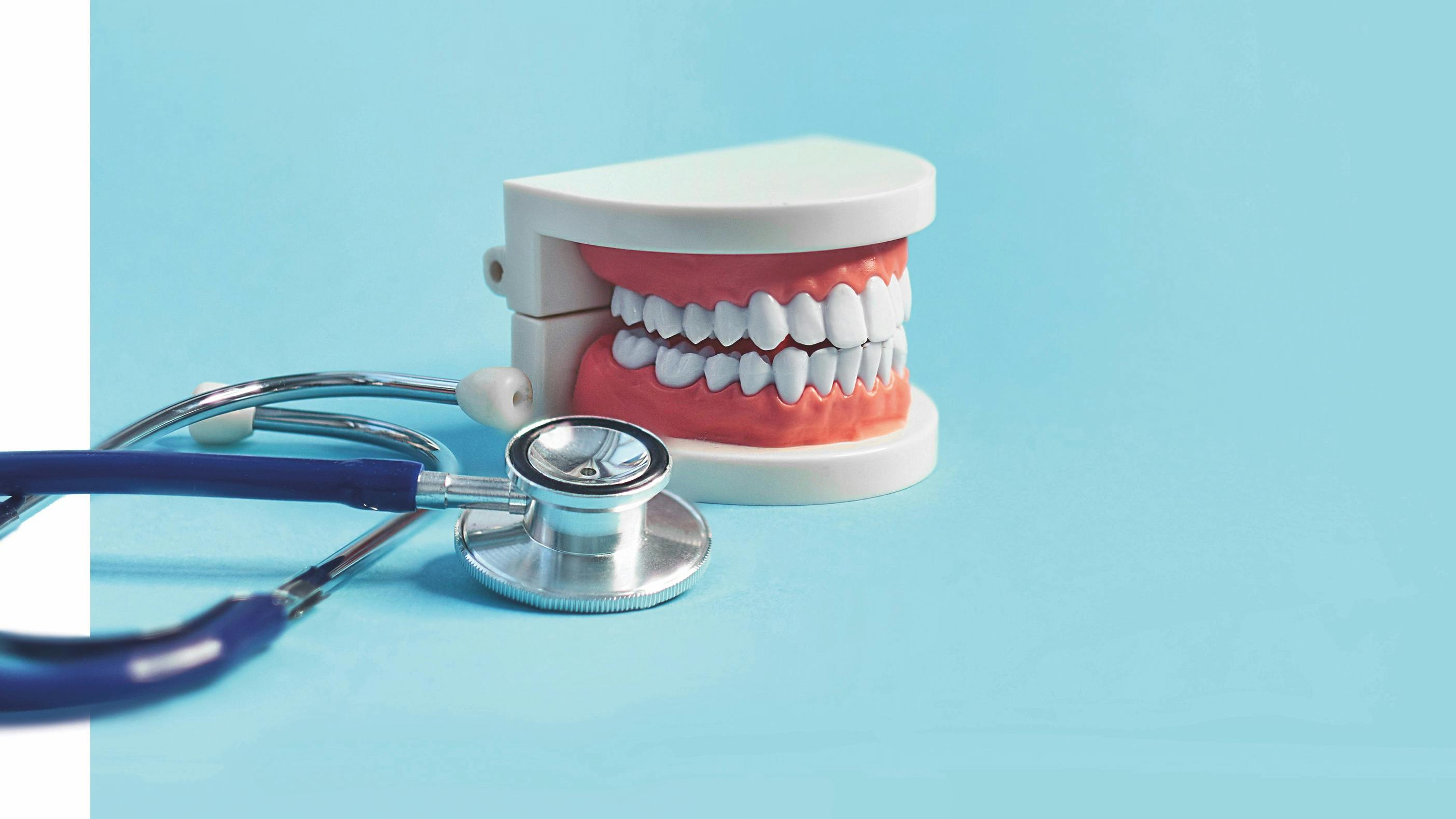 a stethoscope and a model of some teeth denoting metabolic health