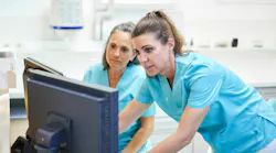 Dental hygienist and assistant reviewing patient care in operatory, illustrating oral preventive assistant role in practice Dental hygienist and assistant reviewing patient care in operatory, illustrating oral preventive assistant role in practice