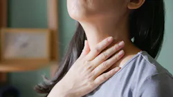a lady with a hand on her neck