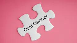 a puzzle piece that says oral cancer on a pink background representing oral cancer awareness