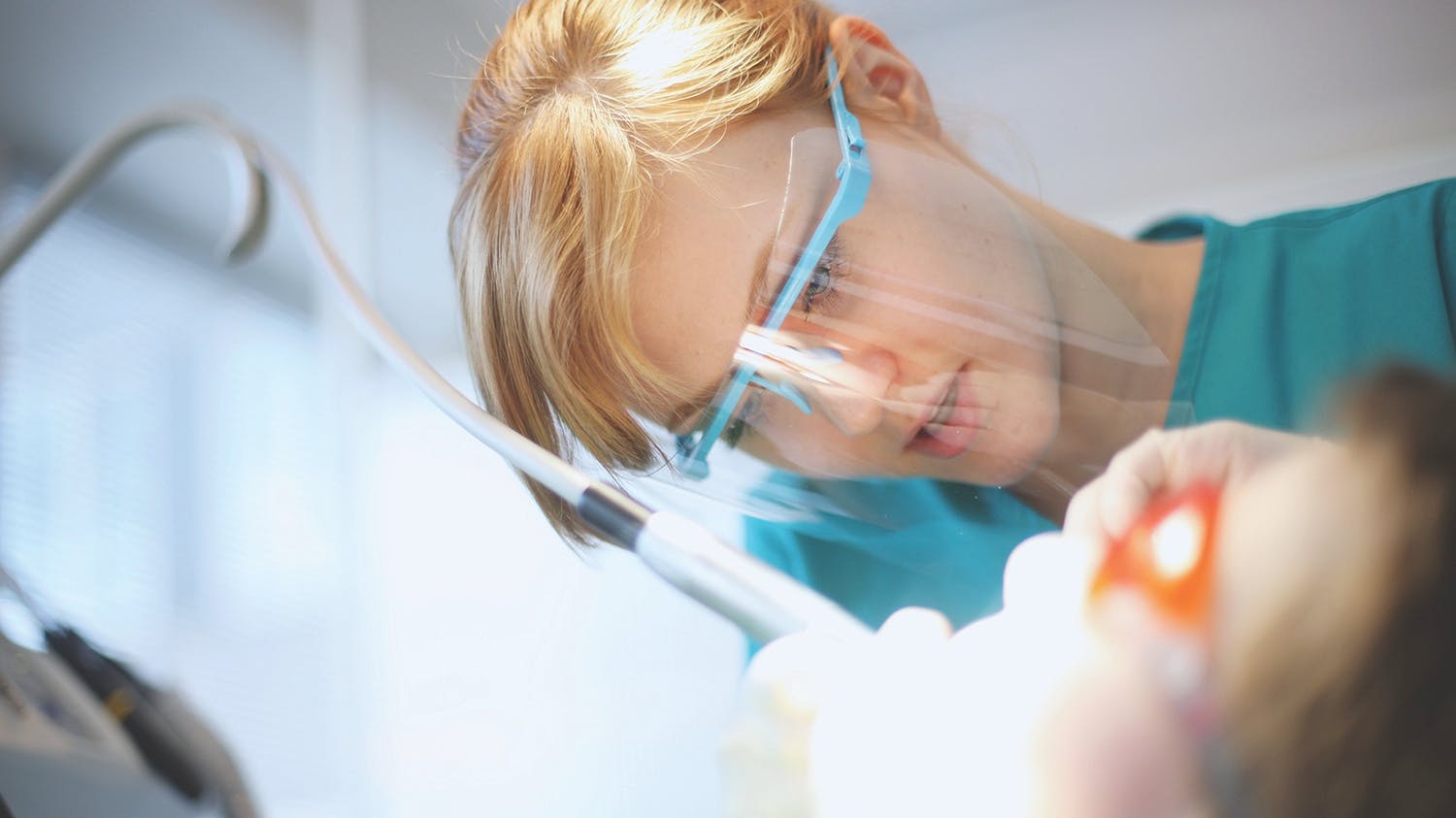 a dental hygienist examining a patient
