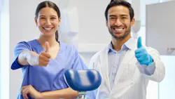 a dental hygienist and a dentist standing side by side giving a thumbs up a dental hygienist and a dentist standing side by side giving a thumbs up