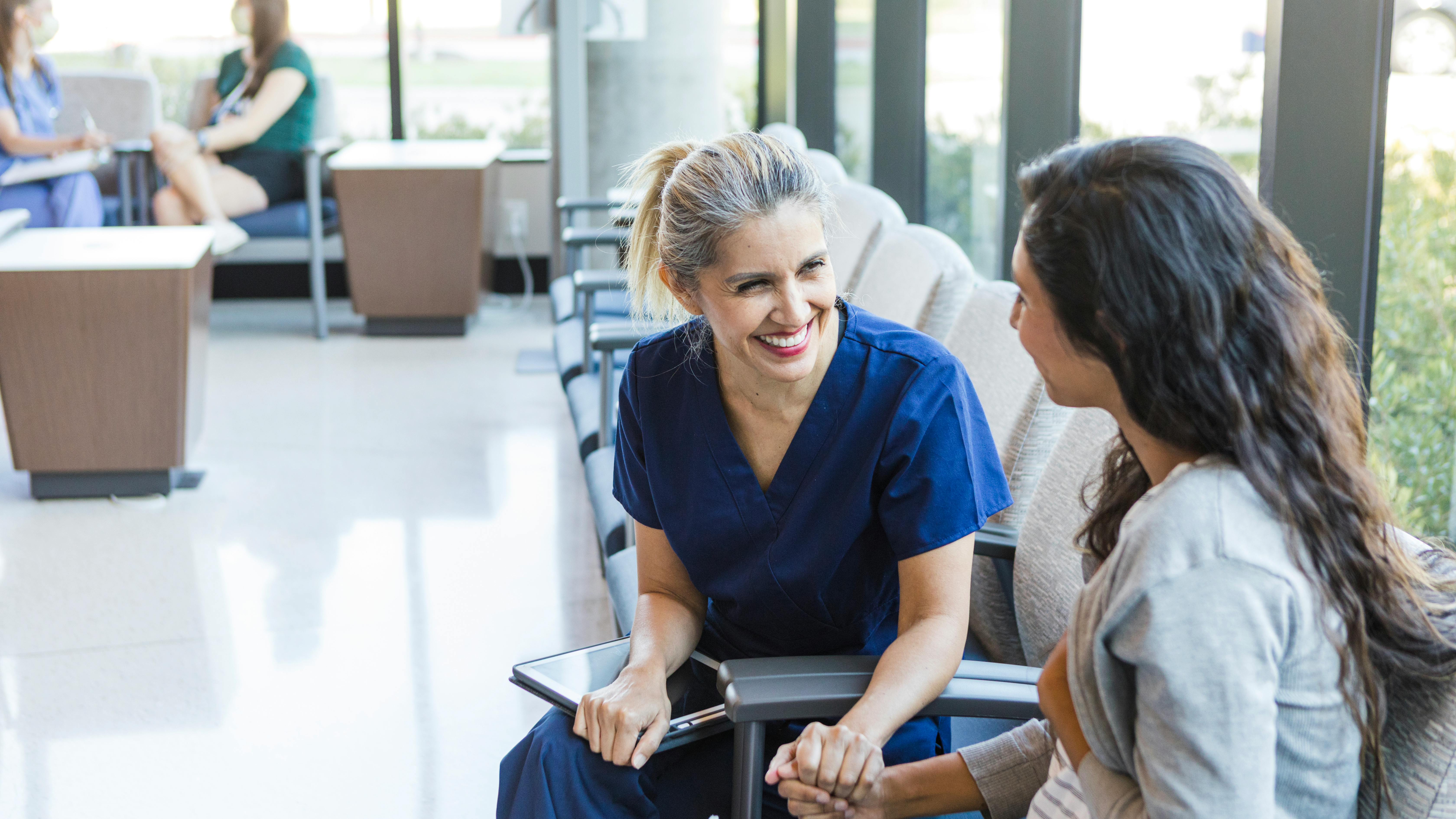 a dental hygienist speaking with a patient
