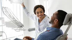 a dental hygienist talking to a patient
