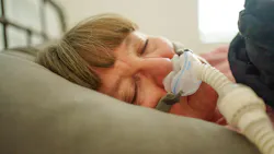 woman sleeping with a CPAP machine