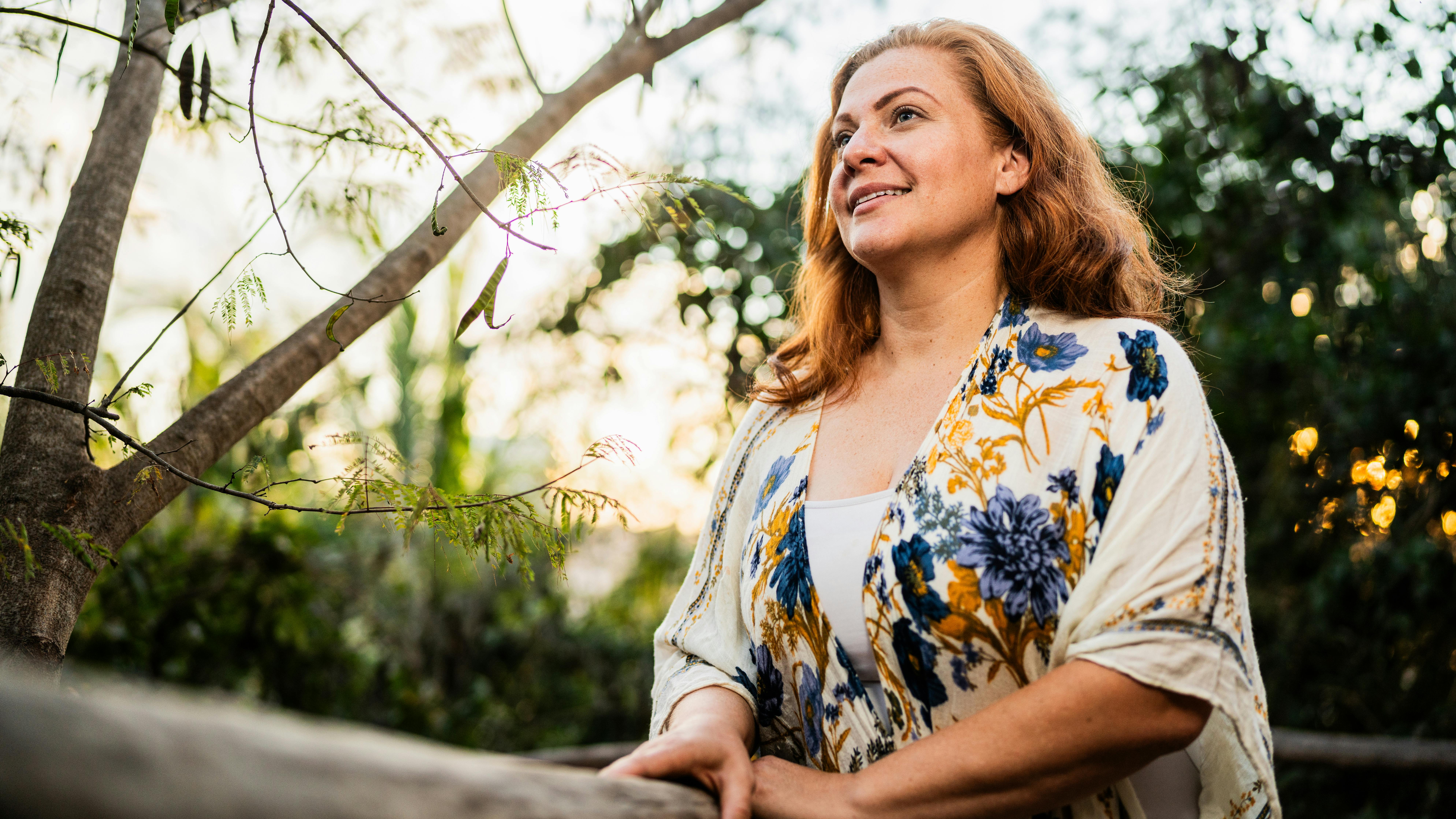 woman sitting outside relaxing and breathing clean air