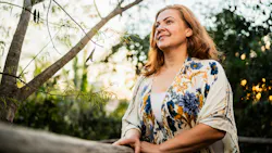 woman sitting outside relaxing and breathing clean air