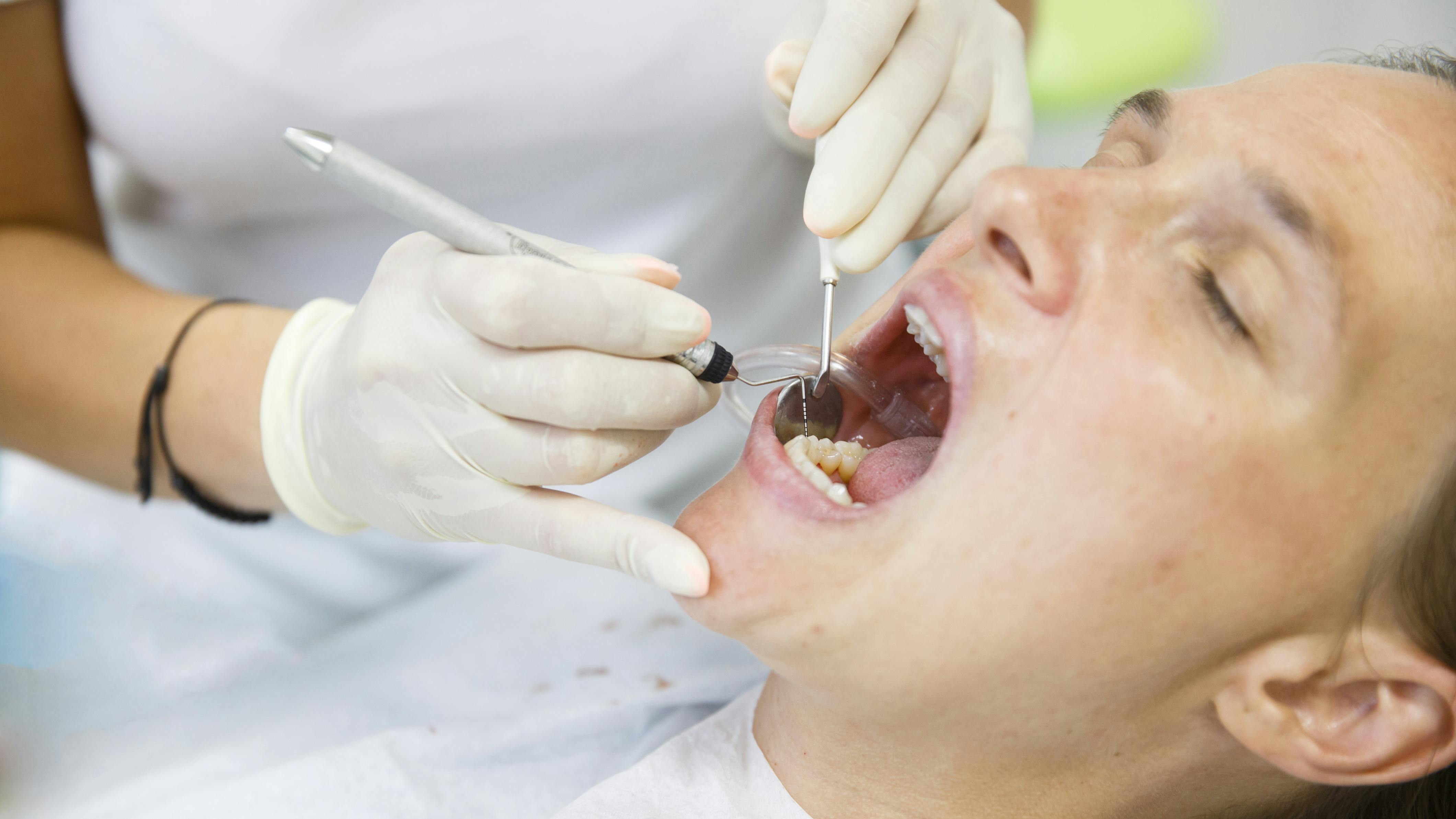 hygienist treating a dental patient