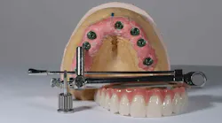 Image of a dental typodont along with a torque wrench used for implants