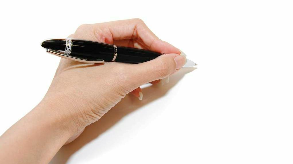 Left hand holding a pen