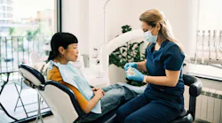 Dental hygienist discussing patient care and clinical findings with a patient