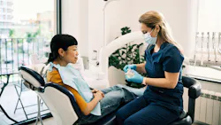 Dental hygienist discussing patient care and clinical findings with a patient
