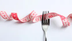 a fork with a measuring tape running through its tines
